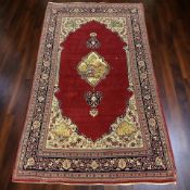 A Kirman rug, South-East Iran, 214 cm x 128 cm.