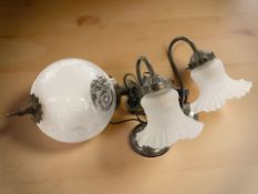 A pair of modern desk lamps with frosted glass shades,