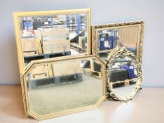 A group of reproduction gilt mirrors, the largest 100 cm x 70 cm.