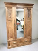 An Arts & Crafts walnut and pine mirrored door wardrobe, 128 cm x 52 cm.