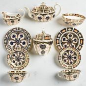 A harlequin Royal Crown Derby Imari porcelain tea for two, comprising teapot, milk and sucrier,