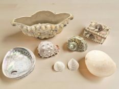 A group of decorative sea shells, shell covered trinket box and bowl.
