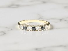 A diamond and sapphire half-hoop ring, stamped 9K, size Q CONDITION REPORT: 1.