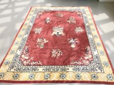 A 20th century Chinese woolen carpet on red ground, 363 cm x 270 cm.