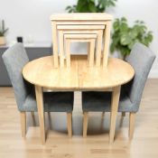 A modern pine effect oval extending dining table, with internal leaf,