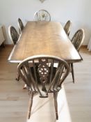 An Ercol stained elm refectory dining table, 183 cm x 82 cm x 77 cm,