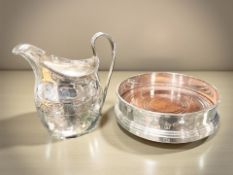 A George III silver milk jug, height 10 cm, and a modern silver and mahogany bottle coaster.