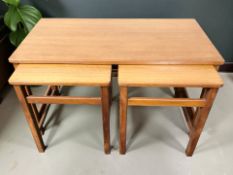 A nest of three teak tables, width 81 cm.