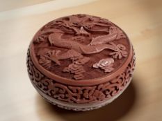 A Chinese cinnabar lacquer circular lidded trinket box, diameter 10.5 cm.