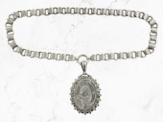 An antique silver locket suspended on white metal chain
