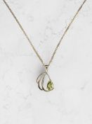 A 9ct gold peridot pendant on chain,