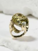 A 9ct gold citrine ring, the large faceted yellow-green citrine in a raised claw setting,