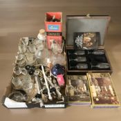 A group of boxed and unboxed drinking glasses, cocktail shaker, soda siphon, decanters, etc.