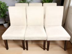 A set of six contemporary dining chairs in cream upholstery.