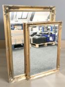 Two reproduction gilt over mantel mirrors, the larger 107 cm x 77 cm.