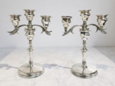 A pair of loaded-silver twin-branch candlesticks, London 1911, height 22cm.