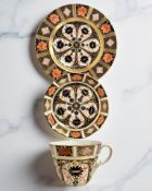 A harlequin Royal Crown Derby Imari porcelain teacup, saucer, and plate trio,