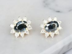 A pair of 18ct gold sapphire and diamond cluster earrings,