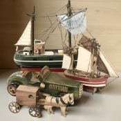 Two miniature scale model boats, largest 23 cm long, a further model horse and carriage,