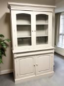 A 20th century painted pine bookcase, with glazed cabinet doors above,