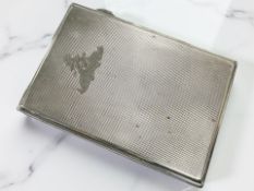 A silver cigarette case with engine turned decoration and engraved Royal Artillery crest,