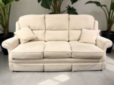 A contemporary three seater settee in beige upholstery, width 215 cm.