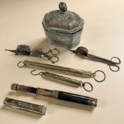 An 18th century lead tea caddy, together with two wrought iron candle snuffers,