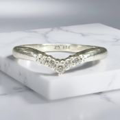 A silver and cubic zirconia wishbone ring.