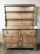 An Ercol stained elm dresser, 123 cm x 49 cm x 160 cm.