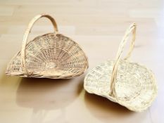 Two wicker log carrying baskets, largest 60 cm wide.
