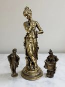 A patinated bronze figure depicting a lady standing by a tree stump, height 24.