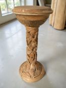 A reproduction heavily carved pine jardinière stand, height 76 cm.