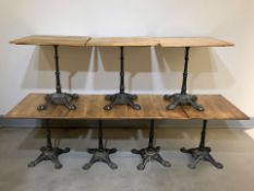 A set of seven pine topped pub style tables on painted cast iron supports, 65 cm x 73 cm x 76 cm.