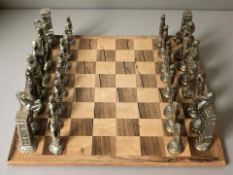 A rosewood chessboard, 42 cm x 42 cm, and a set of die cast metal chess pieces, kings 11.5 cm.