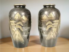 A pair of Japanese Meiji period mixed metal vases depicting mountainous landscapes, each 10 cm high.