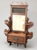 A late Victorian mahogany mirrored wall shelf, width 42 cm,