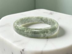 A Chinese jade bangle, diameter 64 mm.