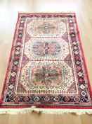 A machine made rug of Caucasian design, 244 cm x 152 cm.