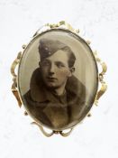 An early 20th century 9ct gold mounted double sided photographic brooch