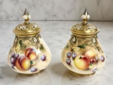 A pair of Royal Worcester porcelain pot pourri vases and covers,