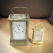 A brass miniature carriage timepiece signed 'Asprey & Son, London', height 9 cm including handle,
