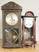 An early 20th century oak wall clock with silvered dial,