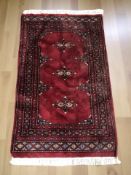 A Lahore Bokhara rug, Pakistan, 106 cm x 62 cm.