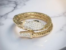 A gilded metal snake spring bracelet, encrusted with cubic zirconia.