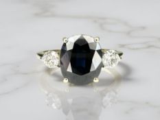 An 18ct gold three stone sapphire and diamond ring,