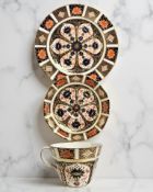 A Royal Crown Derby Imari porcelain teacup, saucer, and plate trio, unfilled gold band border,