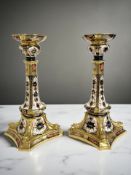 A pair of Royal Crown Derby Imari porcelain candlesticks, pattern 1128,