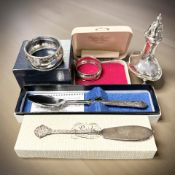 A silver pepperette, two napkin rings,