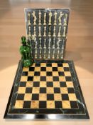 A modern chessboard, signed Colin Millard, together with a set of cast metal chess pieces,
