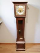 A reproduction grandmother clock, with brass and silvered dial, with pendulum and key,